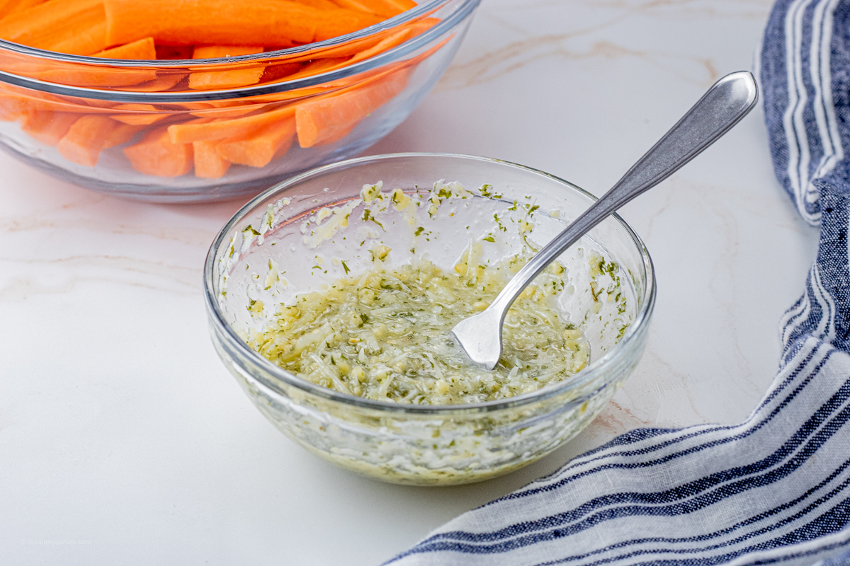 small bowl of garlic parmesan butter with a fork in it