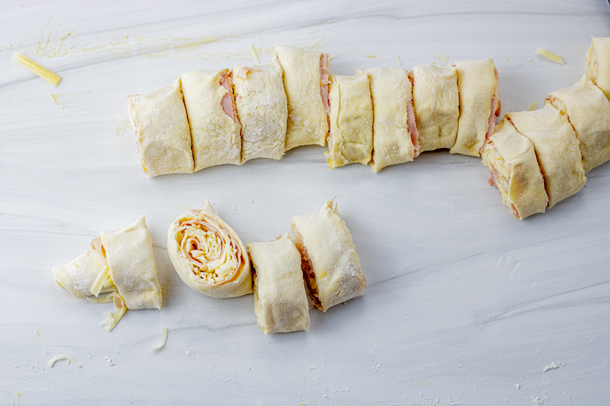 puff pastry filled with ham and cheese, rolled up and sliced into smaller rolls