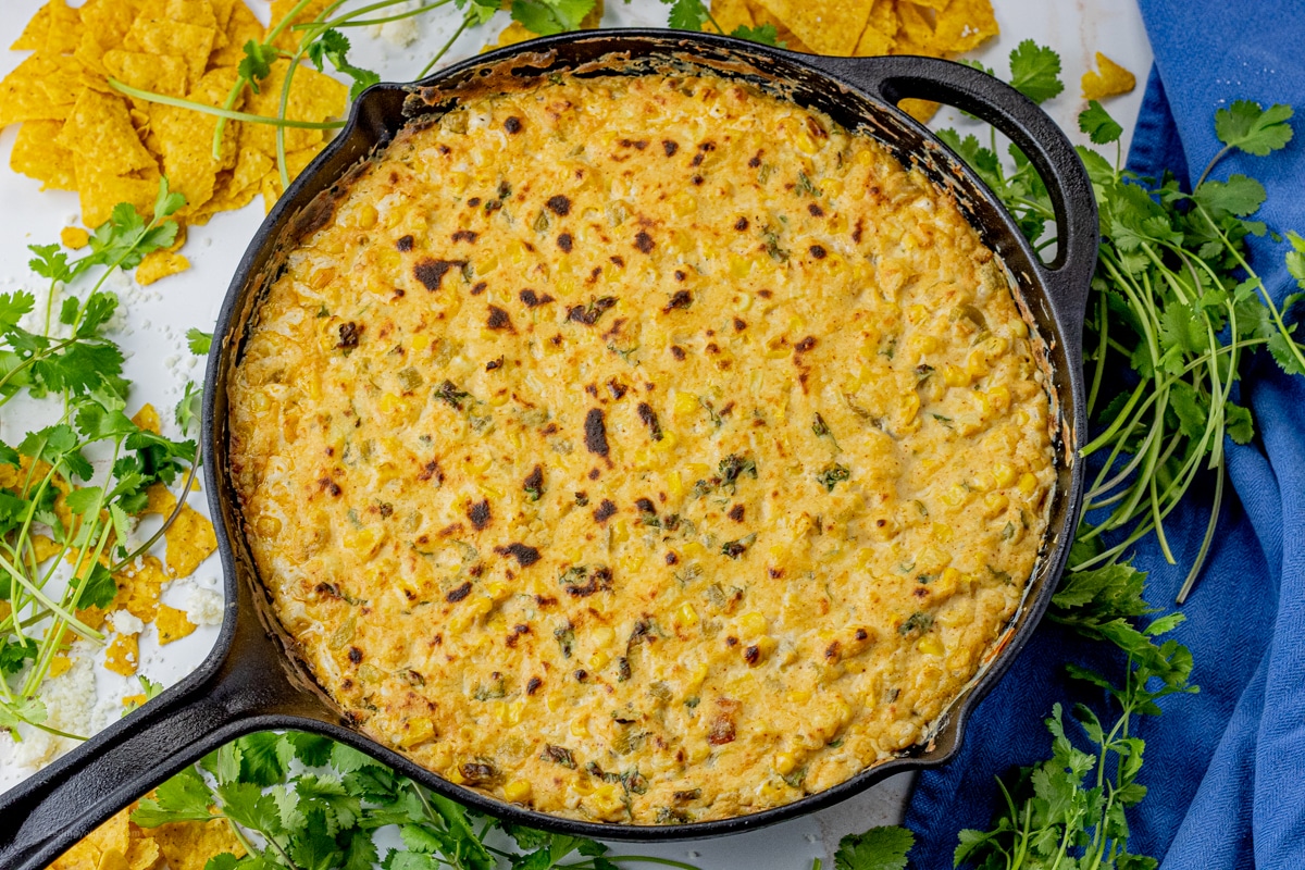 cheesy corn dip in a cast iron pan