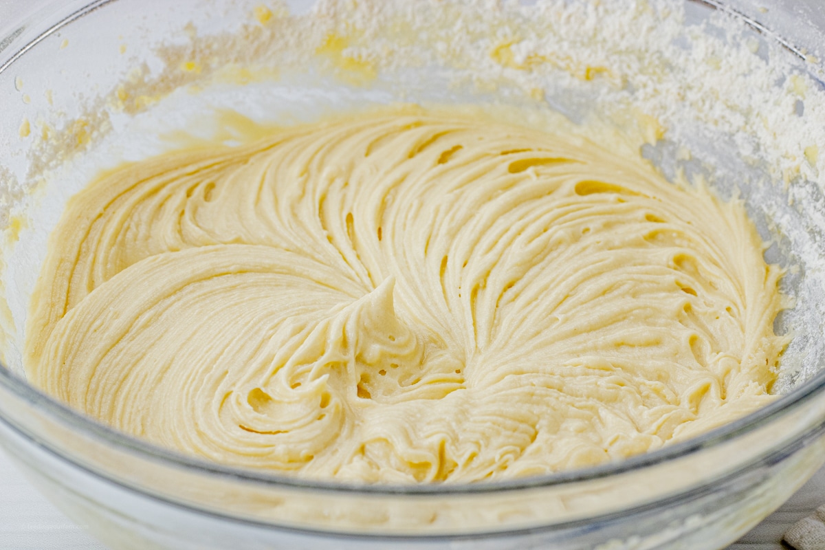 mixed batter for muffins in a glass mixing bowl