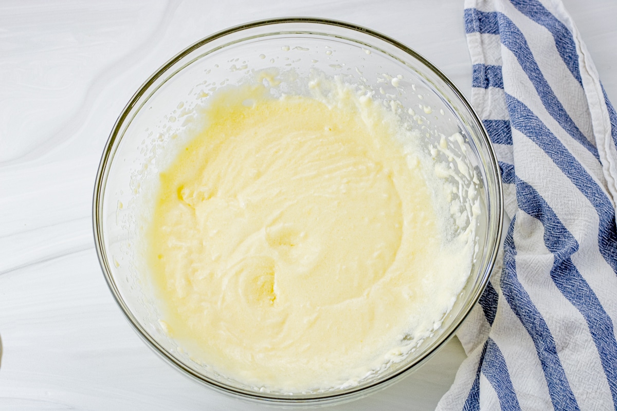 butter, sugar and eggs mixed in a glass mixing bowl