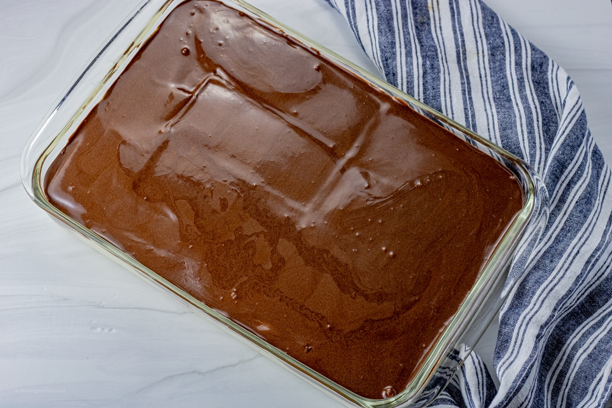 image of chocolate covered eclair cake that is in a glass baking dish