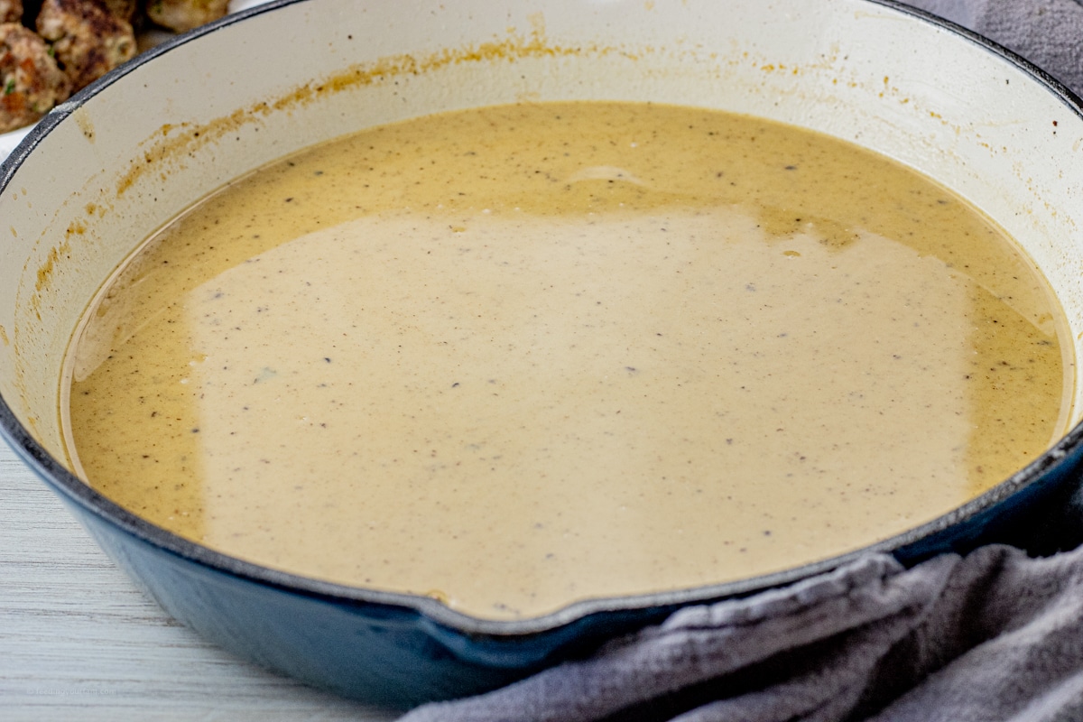 brown gravy in a large enameled cast iron pan
