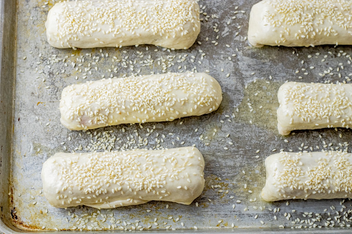 hot dogs wrapped with biscuit dough topped with sesame seeds