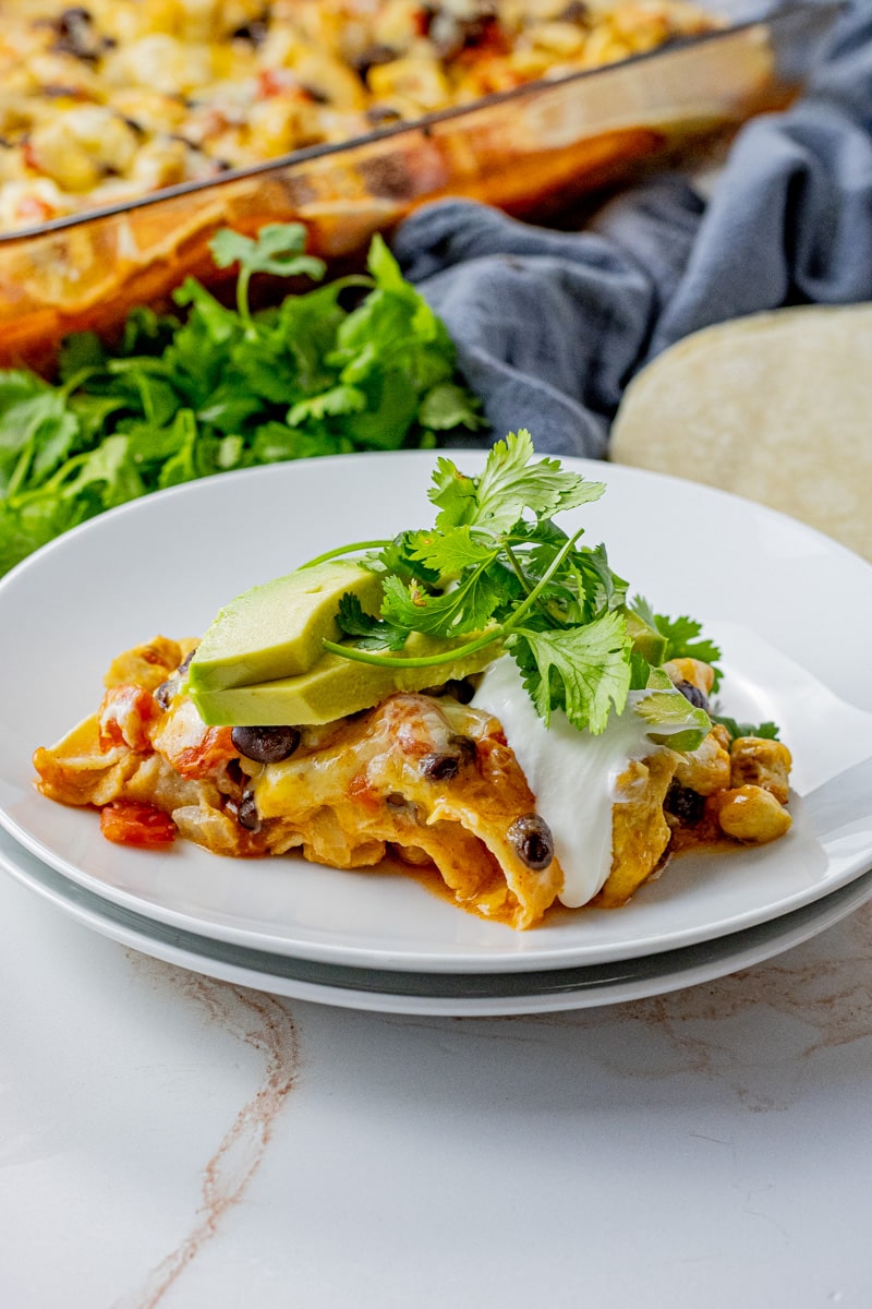 Chicken Tortilla Casserole is a combination of chicken, enchilada sauce, layers of tortillas, and melted cheese to create a satisfying meal.