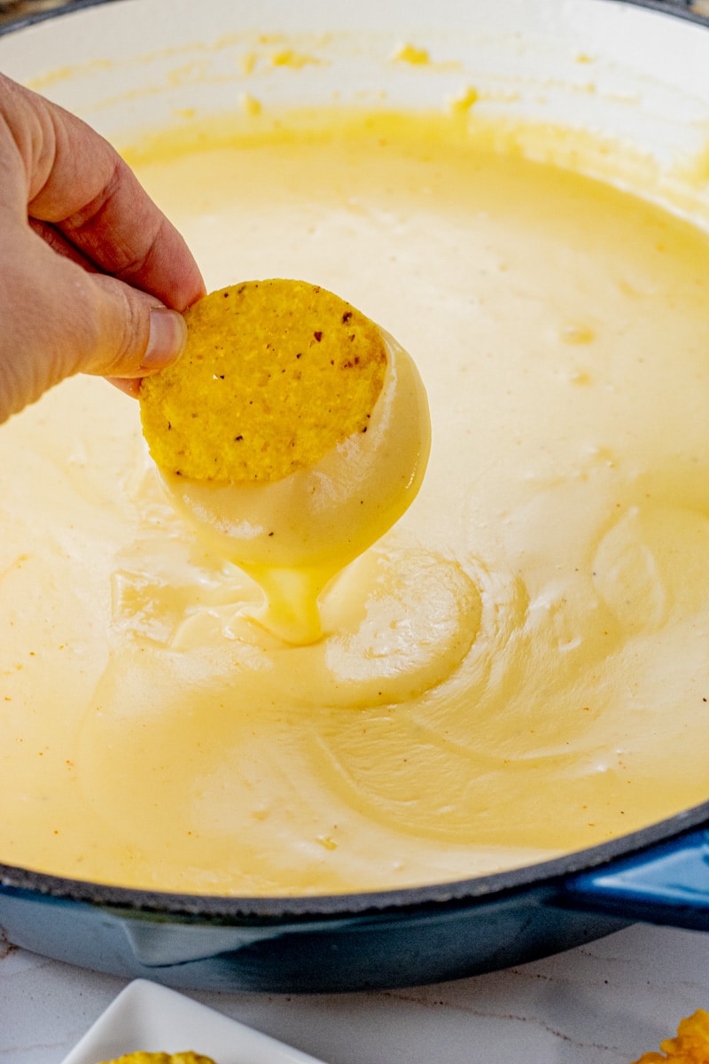 Homemade Nacho Cheese Sauce takes just a few ingredients pour this over tortilla chips, tacos, burritos or even eat it by the spoonful.