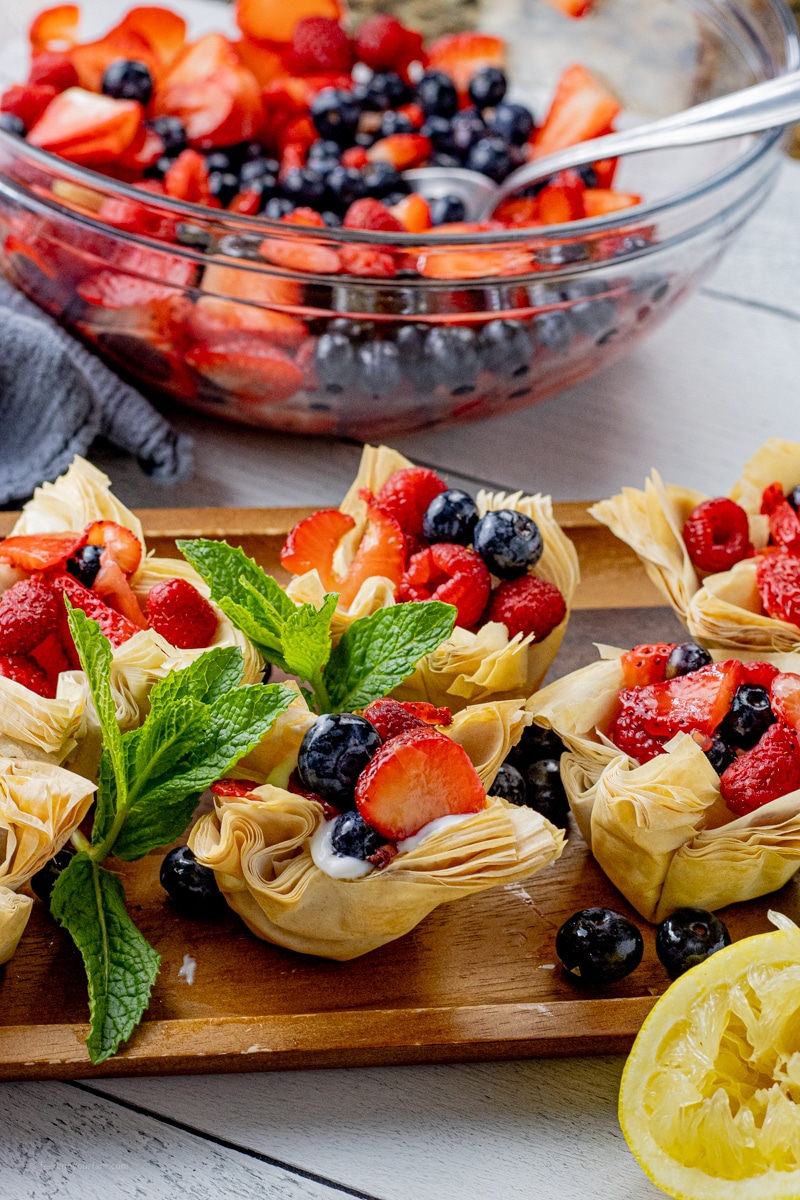 Making mixed berry tarts with phyllo dough is such a simple and impressive way to make an easy dessert. These berry tarts have a crunchy phyllo dough crust filled with vanilla greek yogurt and fresh berries marinated in lemon juice and honey.