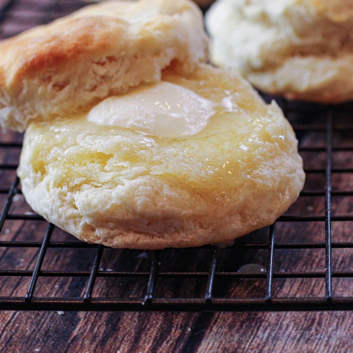 warm biscuit topped with butter and honey