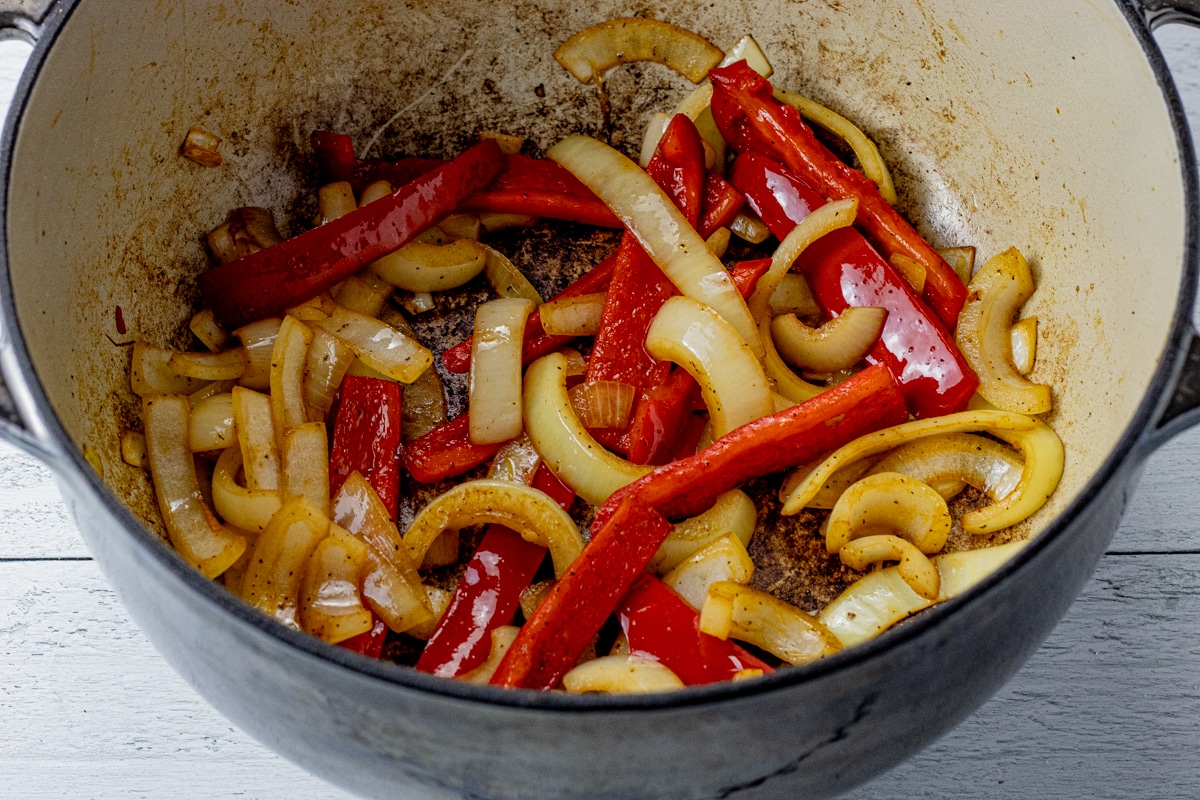 cooked peppers and onions in a dutch oven