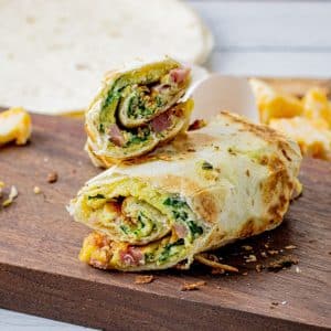eggs, ham and cheese cooked and rolled up in a tortilla