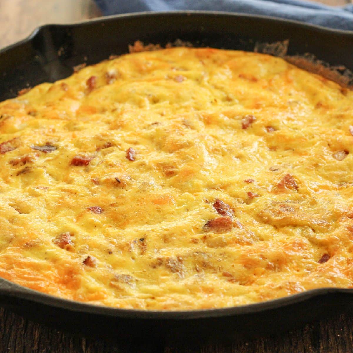 cheesy frittata with ham in a cast iron pan