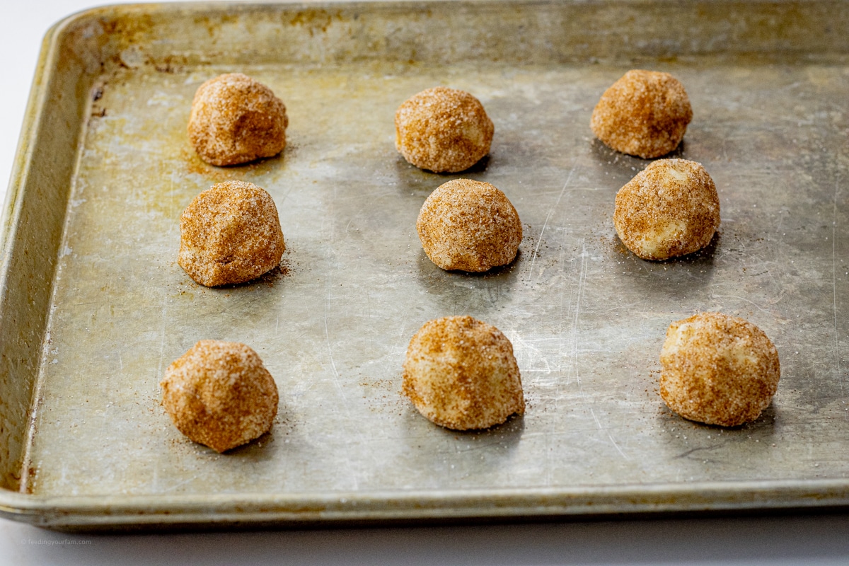 uncooked snickerdoodle cookies on a baking sheet