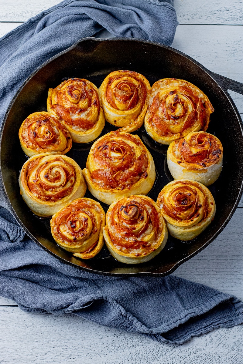 cooked pizza rolls in a cast iron skillet made with pepperoni and cheese