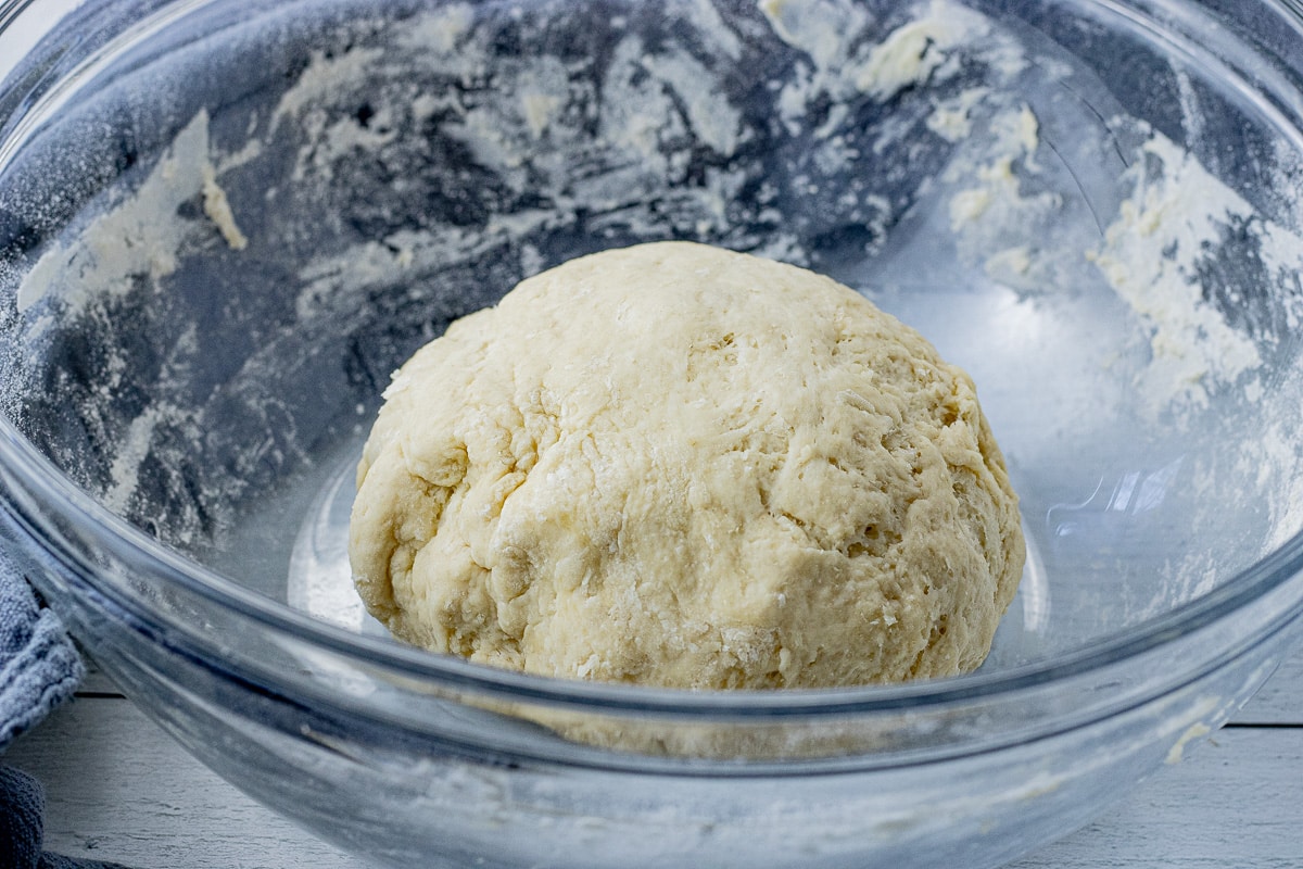 ball of pizza dough in a glass bowl