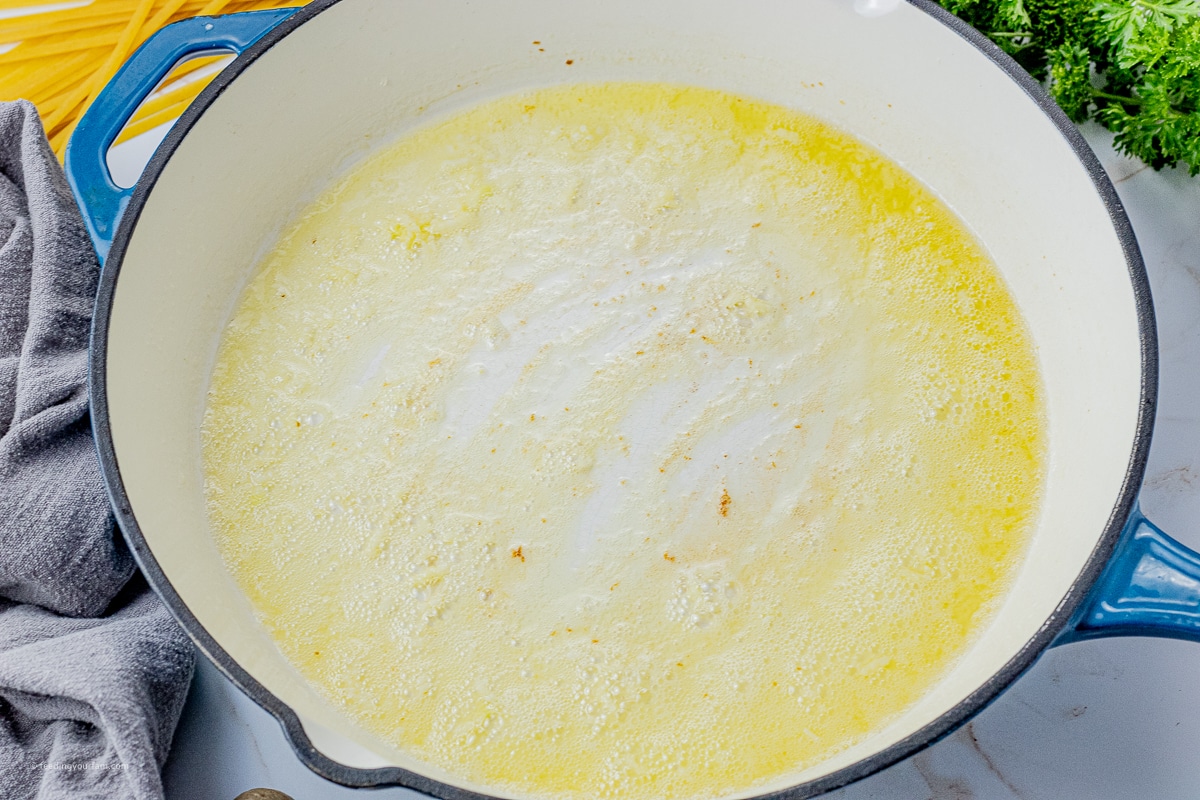 melted butter with garlic in a large skillet