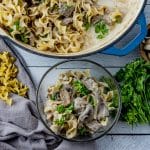 stroganoff made with beef in a large skillet with some in a small glass bowl