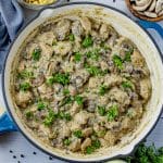 cast iron skillet with chicken in a creamy mushroom sauce