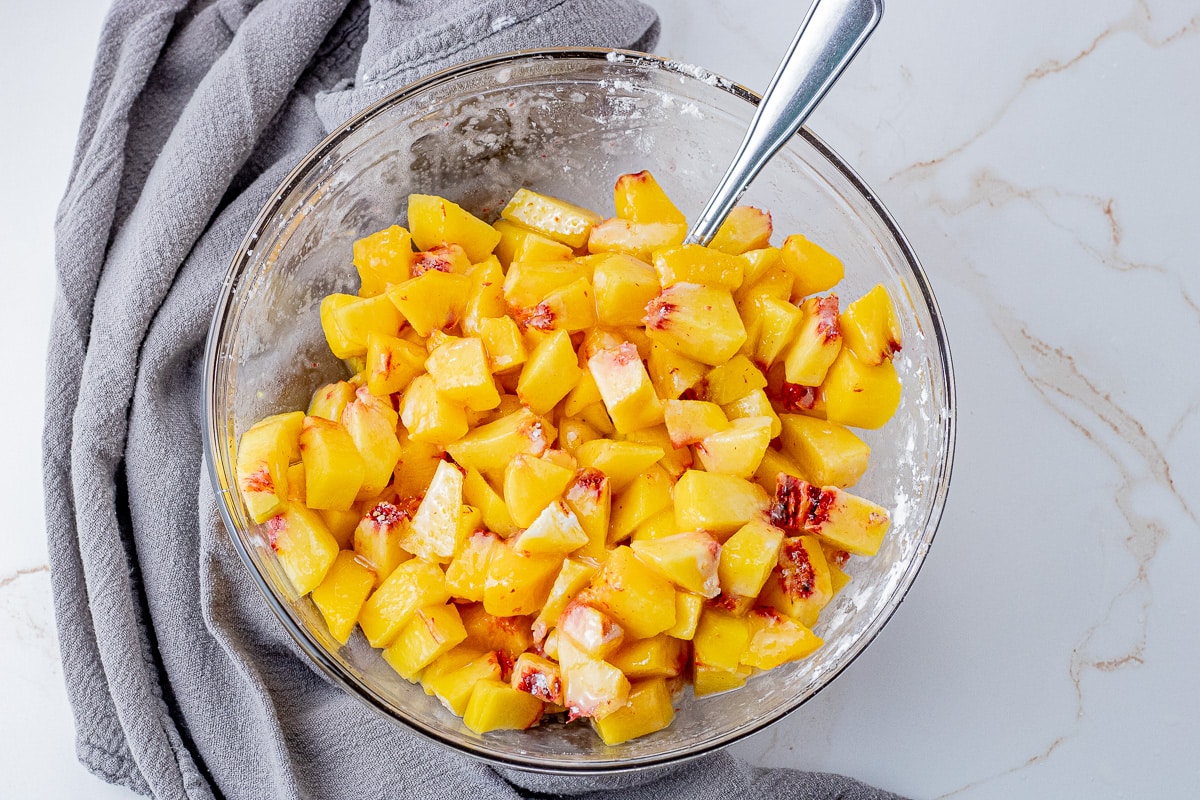 diced peaches in a glass mixing bowl