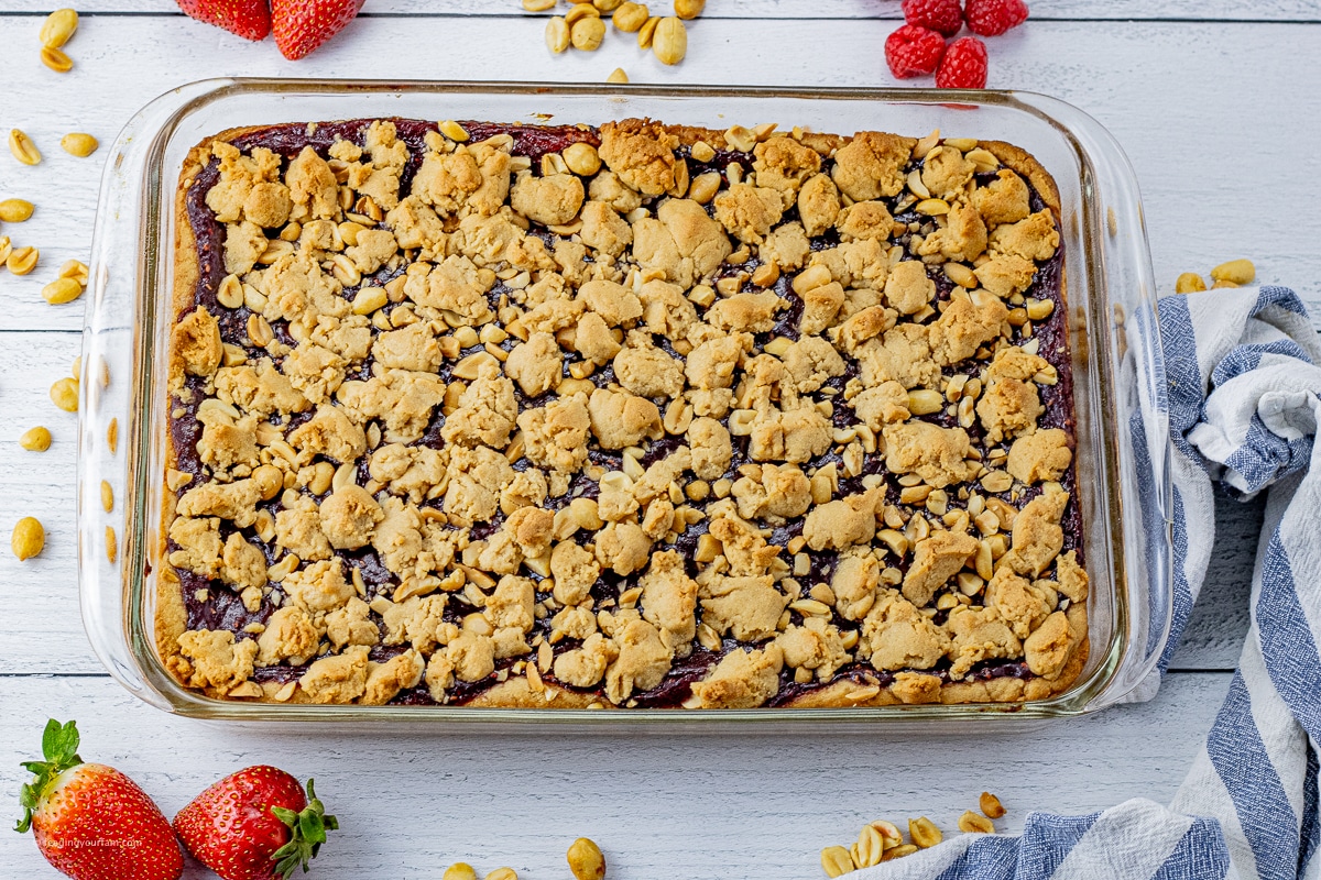 baked peanut butter and jelly bars in a glass 9 x 13 inch baking dish