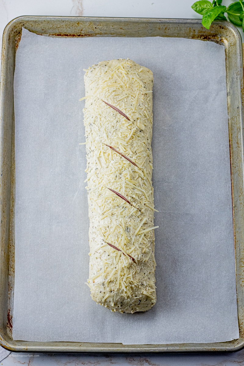 uncooked stromboli on a baking sheet lined with parchment paper