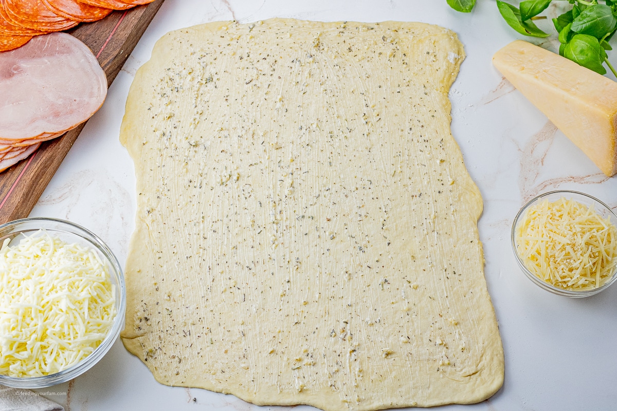 rectangle rolled out pizza dough topped with garlic butter