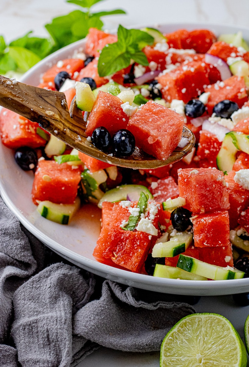 Watermelon Feta Salad is a simple summer salad recipe with watermelon, cucumbers, mint and a delicious honey lime dressing.