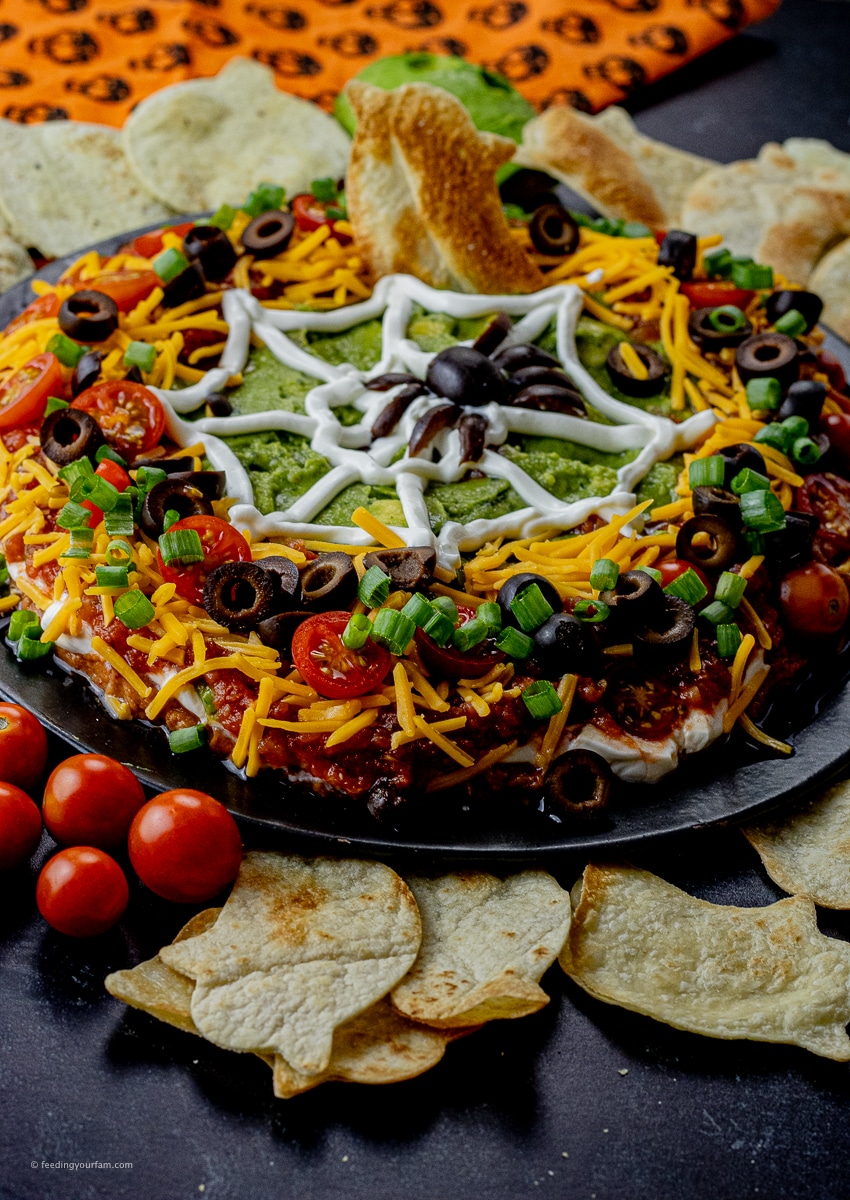 Halloween 7-layer dip is the perfect way to elevate your Halloween party game. This spider web 7 layer dip is super easy to make and is always frightfully delicious. Loaded with delicious flavors, this is the perfect dip to thrill all the little ghosts and ghouls.
