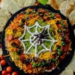 7 layer dip with a sour cream spider web on top