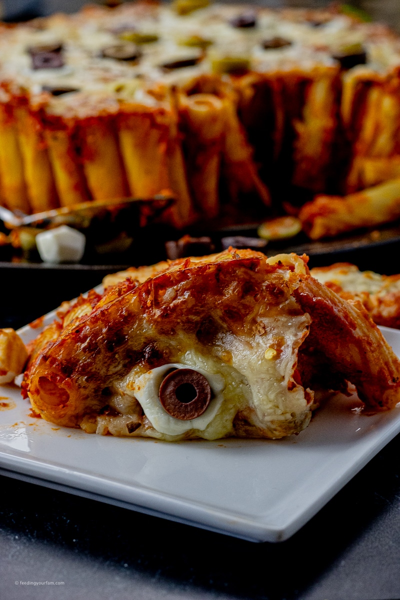 Baked Rigatoni with Eyeballs is a simple, creepy Halloween recipe made with rigatoni, pasta sauce, cheese and olives. Perfect for a Halloween party main dish.