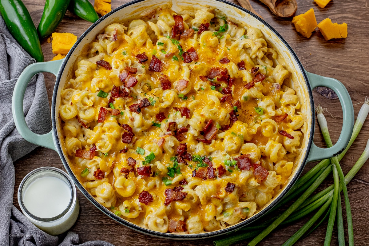 bacon, jalapeno mac and cheese with swirly pasta topped with bacon pieces and melted cheese