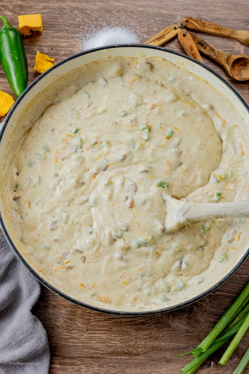 sauce made with milk, flour, jalapenos, cream cheese and cheddar cheese in a large pan