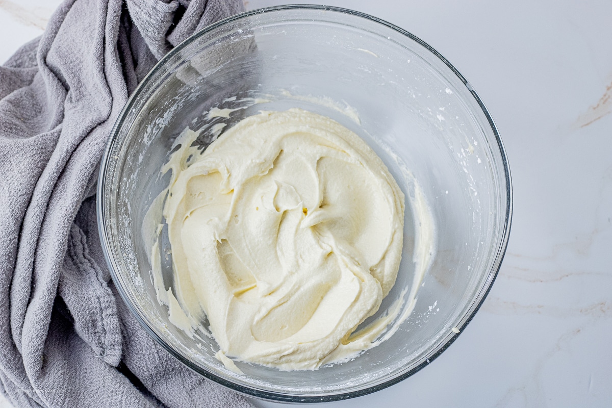 white, maple frosting in a glass mixing bowl