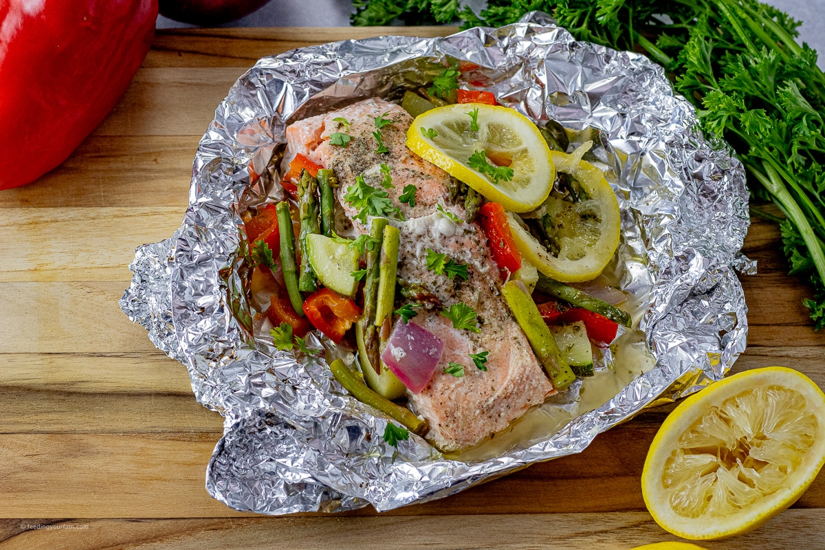 baked salmon in a sheet of foil with vegetables