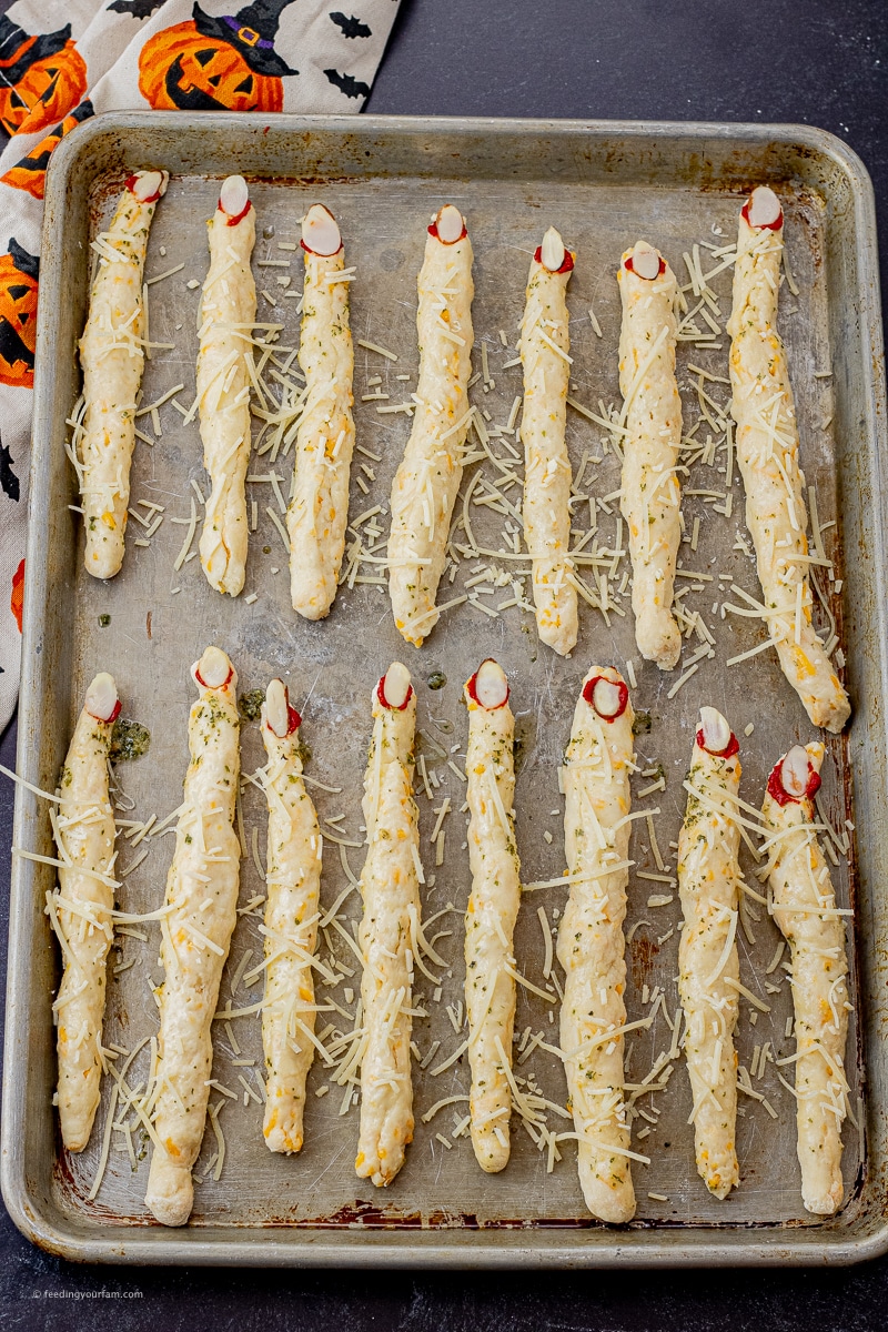 uncooked witch finger breadsticks on a baking sheet