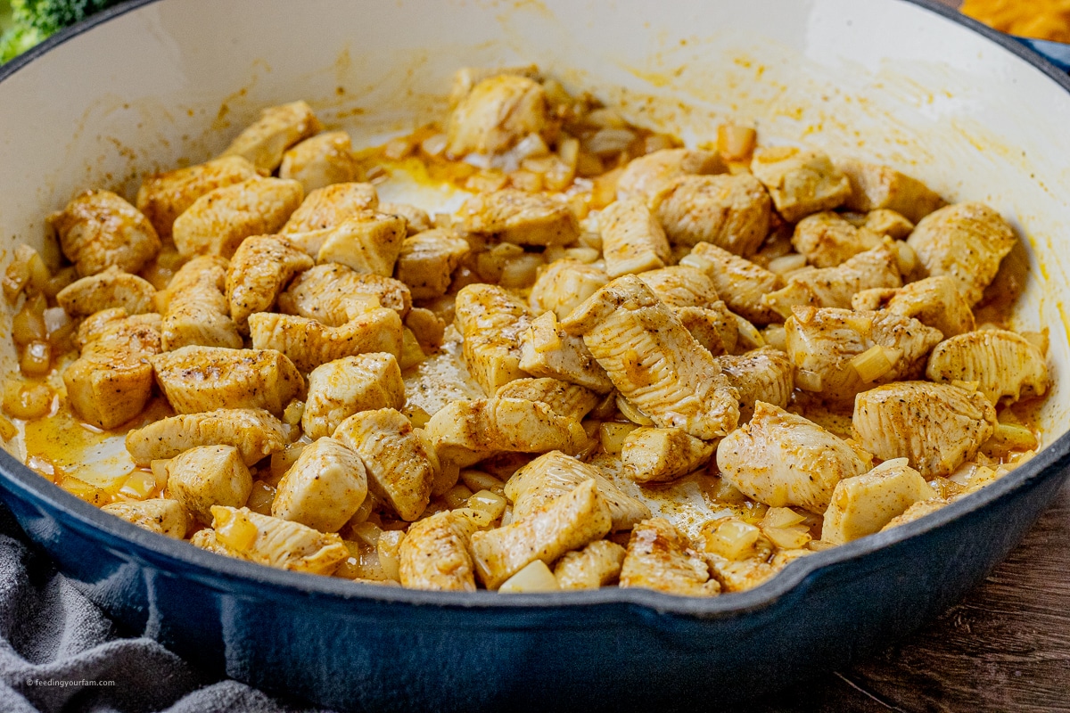 cubed chicken in a cast iron pan