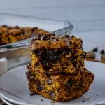 two chocolate chip pumpkin bars on a white plate
