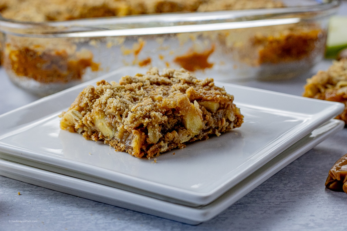 apple caramel bar sliced into a square on a white plate