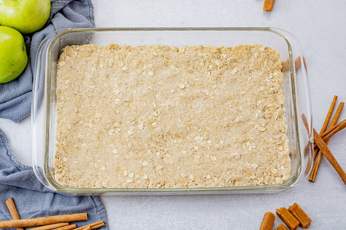 buttery oat crust in the bottom of a glass baking dish