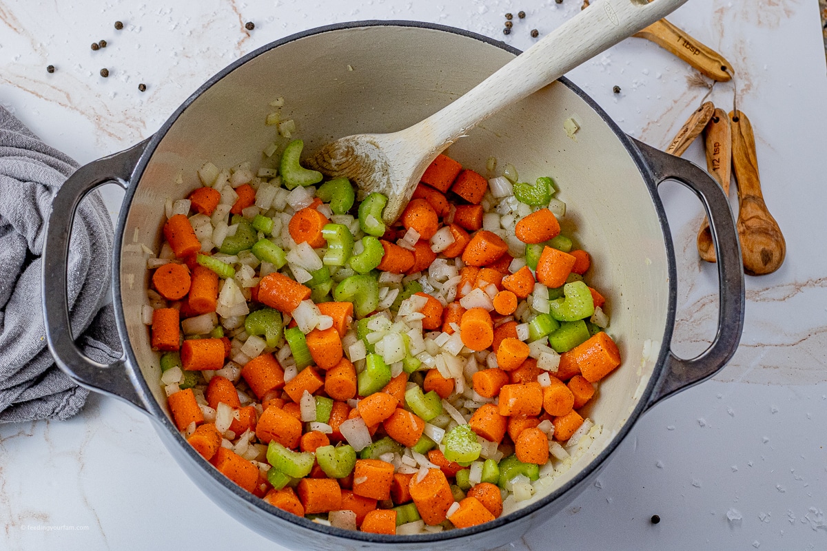 big pot with chopped carrots, onions and celery 