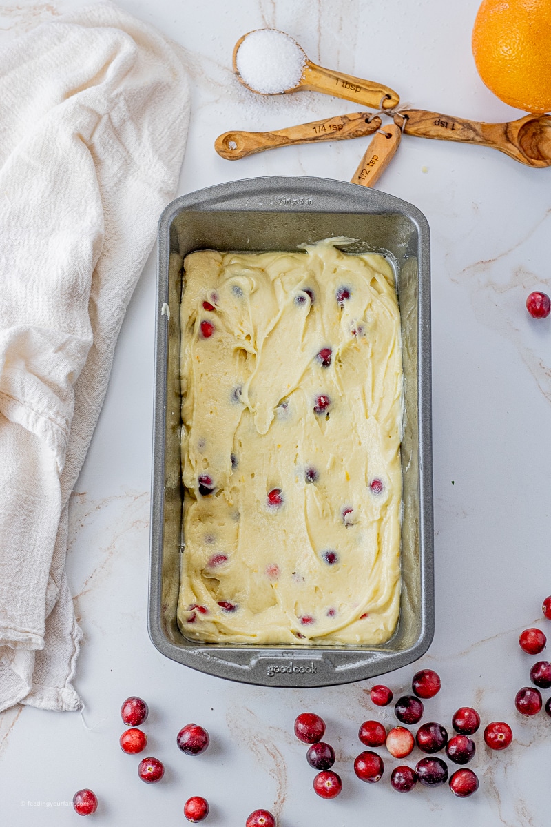 cranberry orange quick bread batter in a loaf pan