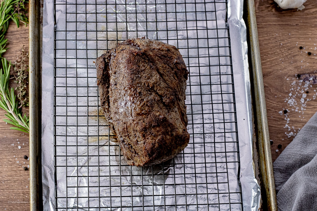 roasted beef tenderloin on a baking rack on a foil lined baking sheet