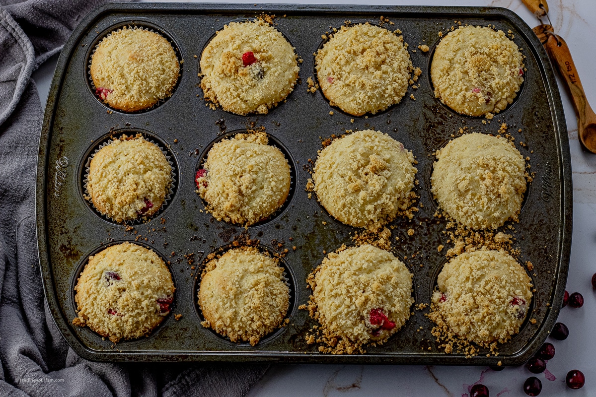 cranberry orange muffins baked and in a muffin pan