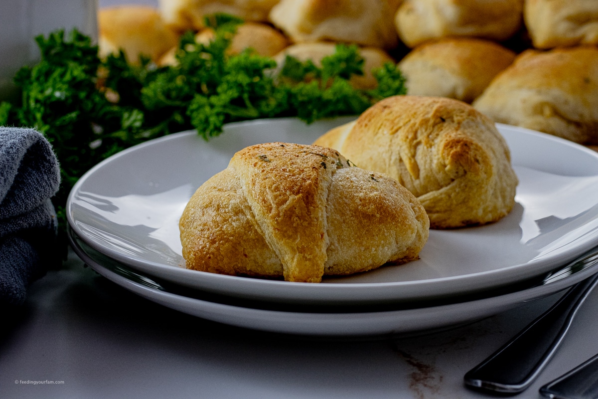 crescent rolls stuffed with chicken and cheese on a white plate