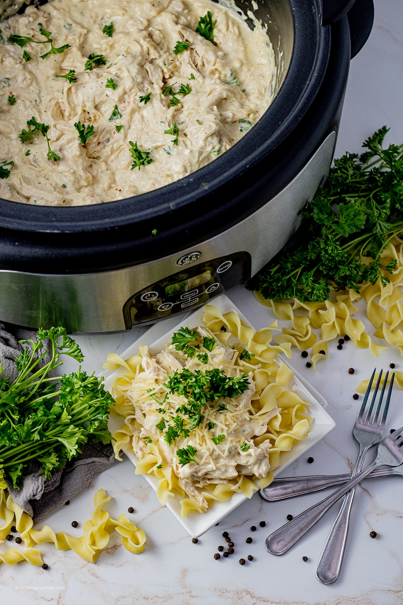 shredded chicken in a creamy sauce in a slow cooker