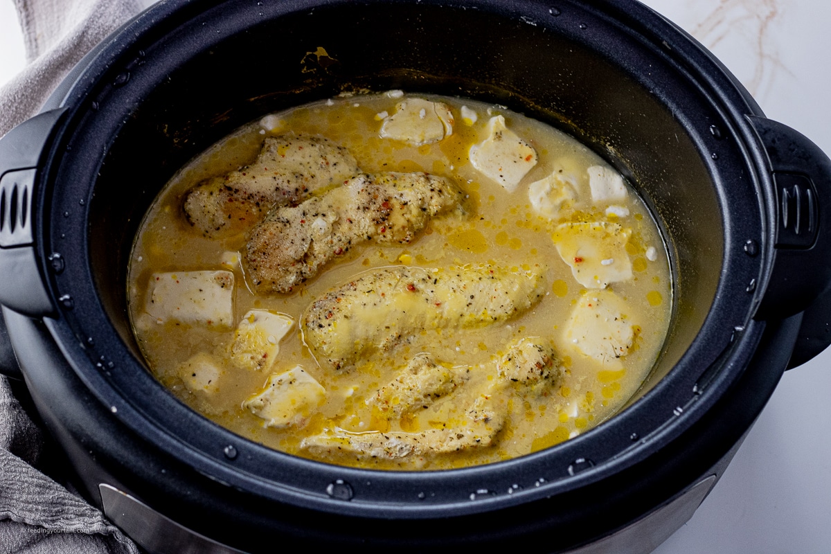 chicken in broth in a slow cooker