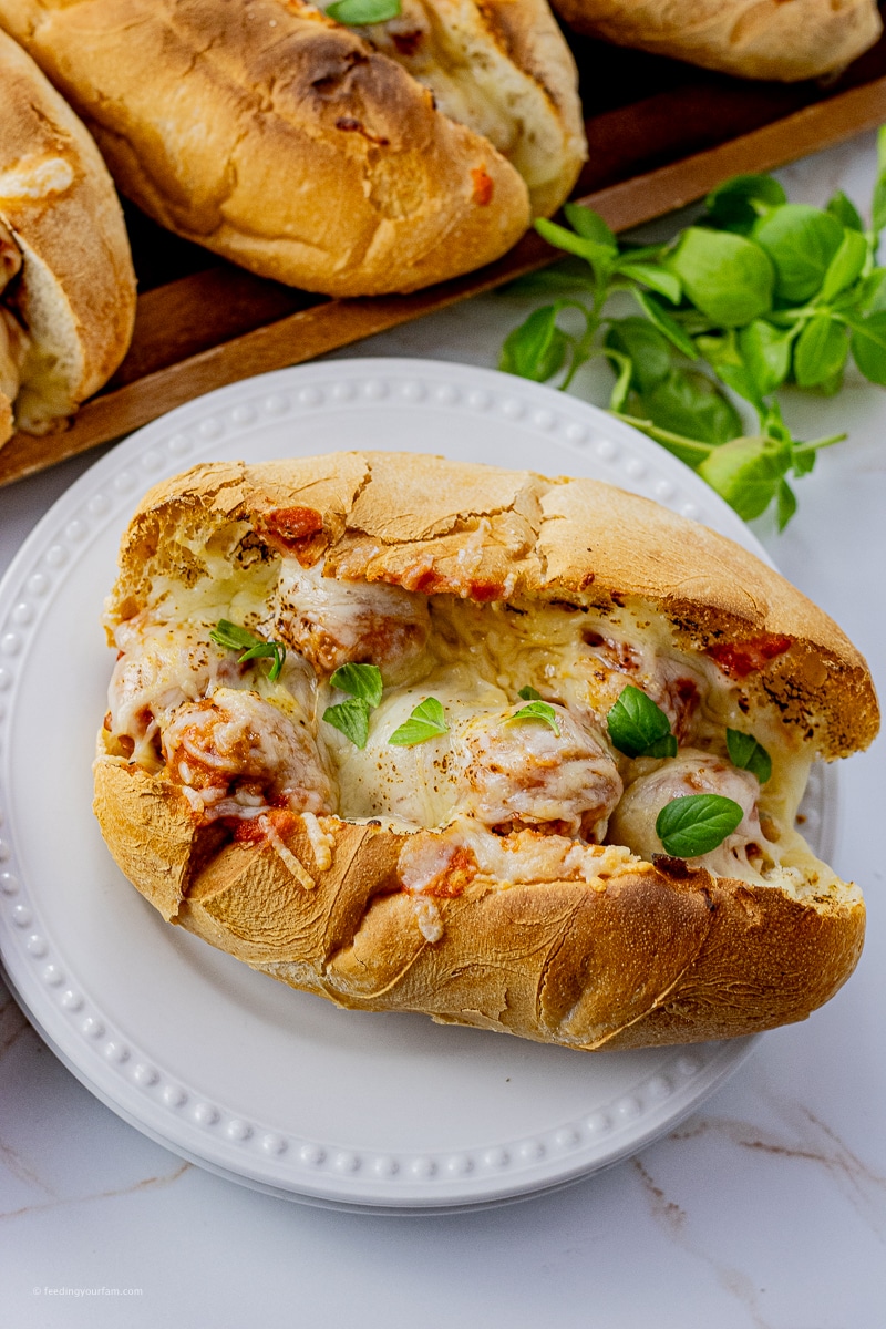 Cooking Meatball Sandwiches in a slow cooker is a delicious and effortless way to get dinner on the table for the fam. Picture, juicy meatballs in a savory sauce stuffed into soft hoagie buns all topped with melted mozzarella and parmesan cheeses.