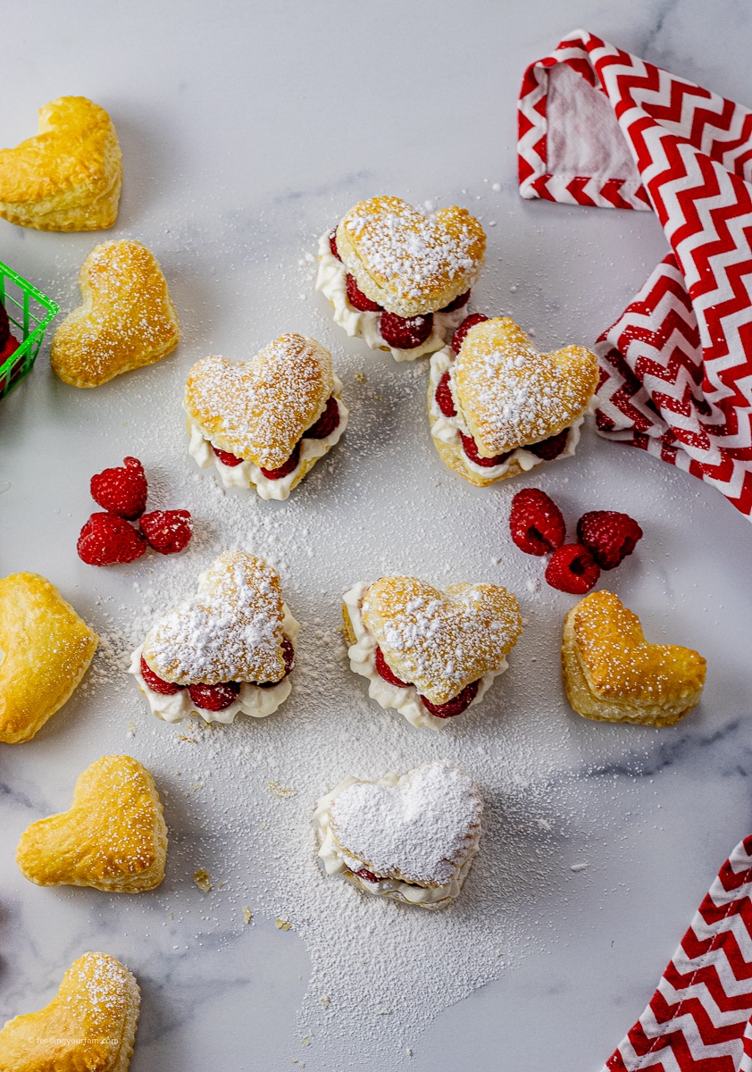 heart shaped puffed pastry filled with cream and raspberries