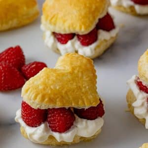 heart shaped cream puff, filled with cream and raspberries