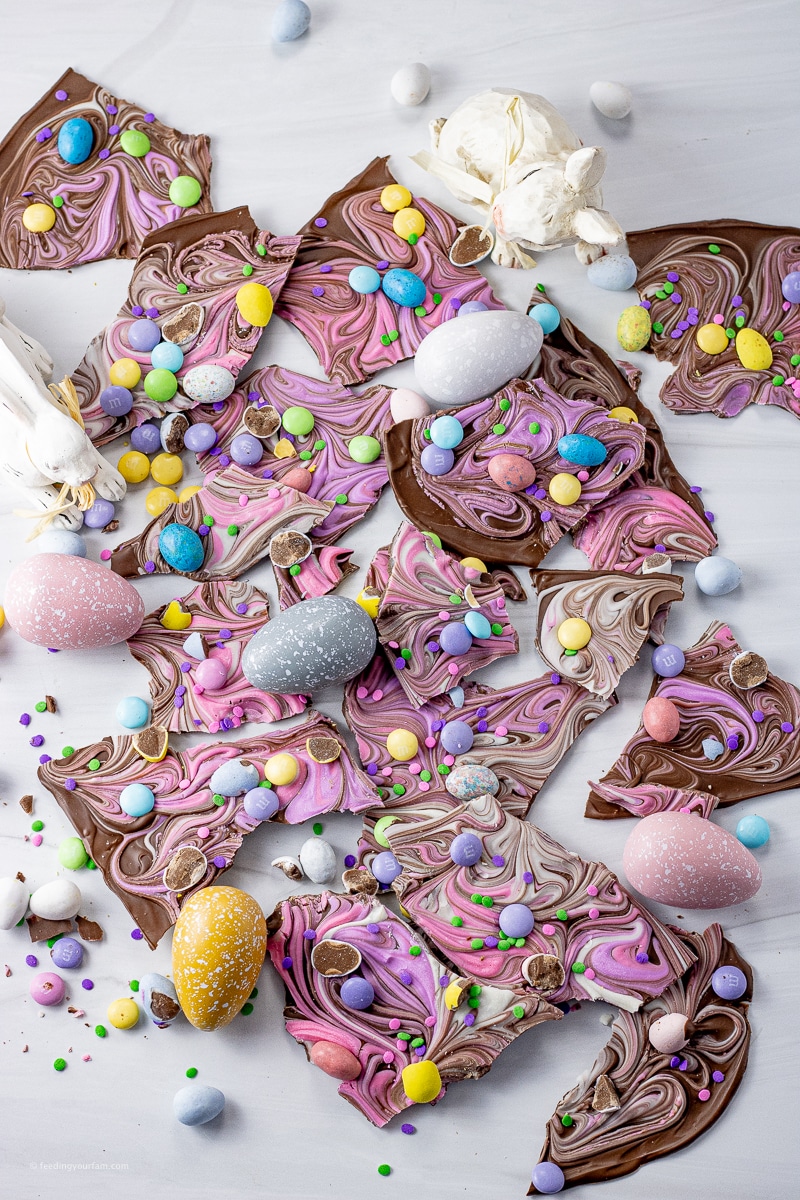 chocolate bark with swirls of pastel colors and topped with small easter candies