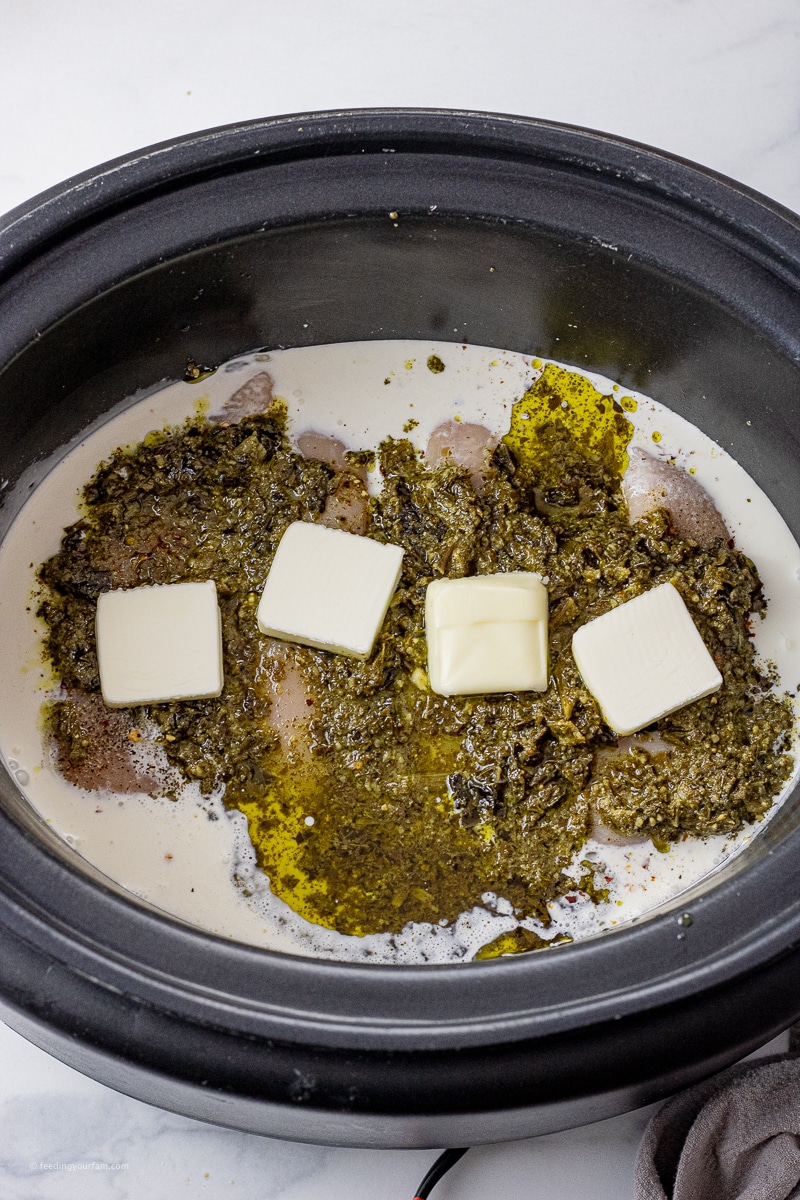 chicken, pesto, cream, butter and broth in a slow cooker pot